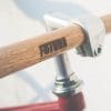 Bicycle handlebar with wooden grip showcasing "Fortuna" branding, emphasizing craftsmanship and design in the context of digital marketing services.
