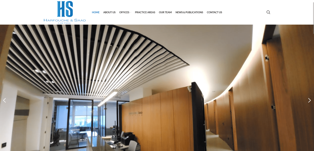 Modern office interior of Harfouche & Saad law firm, featuring sleek design elements, wooden accents, and contemporary lighting, emphasizing a professional atmosphere.