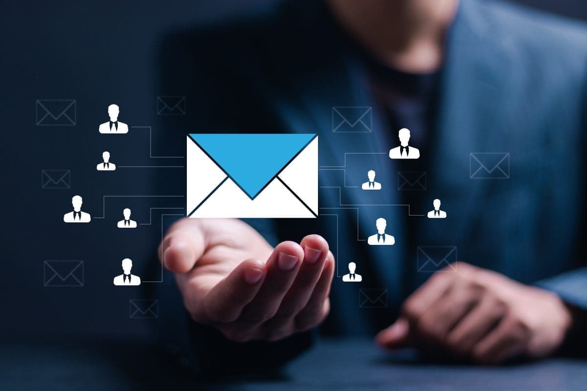 Hand reaching out with a graphic of an envelope and icons representing customer connections, illustrating SMS marketing engagement strategies for businesses.